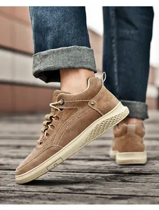 Detail of men high-top suede shoes with contrast stitching and honeycomb texture sole
