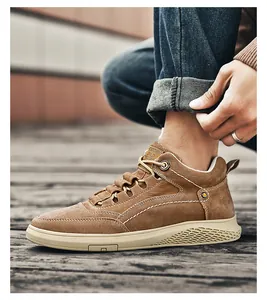 Detail of men's brown high-top sneaker with suede texture and contrast stitching