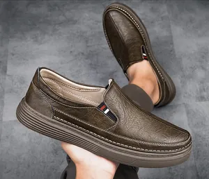 Detail of brown leather slip-on shoe with lychee texture and contrast stitching