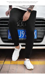 Detail of white cowhide leather loafers with drawstring design on an Audi car background