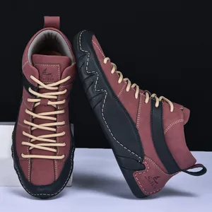 Detail of burgundy leather high-top shoes with Salkin logo and wave rubber sole