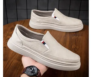 Detail view of men's leather loafers featuring lychee texture and tricolor side ribbon