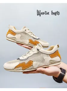 Detail of men's breathable mesh casual shoes with orange accents and outdoor style laces