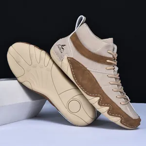 Macro shot of khaki men's high-top boots featuring non-slip rubber soles and logo detail
