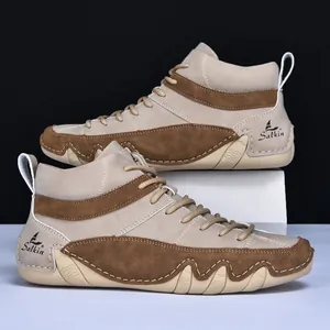 Detail of khaki high-top men boots showing contrast stitching and durable rubber sole