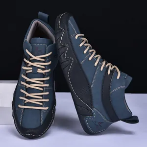 Close-up of blue-grey leather casual shoes with white stitching and round woven laces