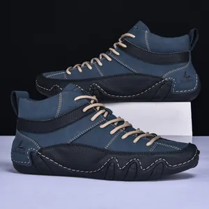 Detail of high-top casual men's boots featuring navy nubuck leather and textured soles