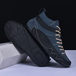 Detail of dark blue high-top men's boots with non-slip rubber soles and durable laces