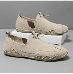 Close-up of beige leather loafers featuring drawstring clasp and rugged anti-slip rubber soles