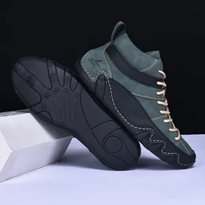 Detailed view of men's dark green suede high-top boots featuring durable rubber soles