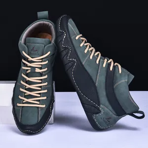 Detailed view of high-top men's green suede boots with black leather accents and brown laces