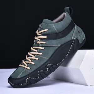 Detail of dark green suede high-top boot with white stitching and wavy sole design