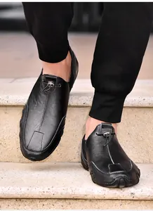 On-foot view of black leather casual loafers featuring textured grain and toggle drawstring