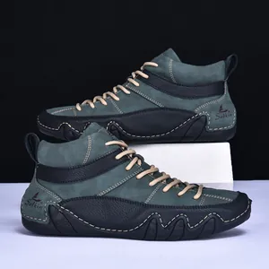 Detail of high-top casual boot featuring dark green nubuck and black leather stitching