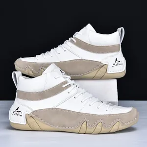 Detailed close-up of high-top men's shoes featuring white leather and khaki suede panels