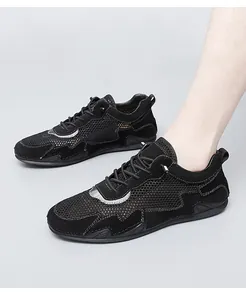 Detail of men's black breathable mesh shoes with suede trim and lace-up design