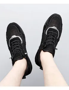 Close-up of breathable mesh fabric and suede panels on black men's casual sneakers