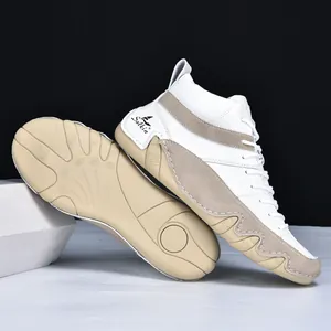 Detail of wave-patterned anti-slip sole on white leather and beige suede sneakers