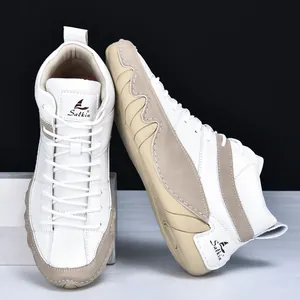 Detail view of high-top casual sneakers with khaki leather stitching and Salkin logo