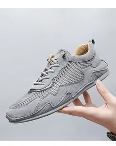 Detail showing breathable mesh fabric and grey suede stitching on men's casual shoe