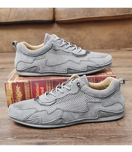 Detail of grey men's casual mesh shoes with breathable hollow texture and suede overlays