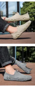 Detail of suede leather loafers showing beige and grey colors with anti-slip rubber soles