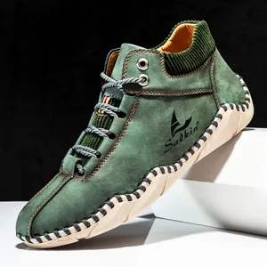 Men's high-top dark green suede boots with distinctive manual hand-stitched welt design