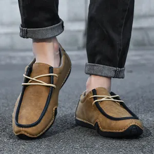 Detail of tan casual loafers for men featuring hand-stitched seams and textured leather