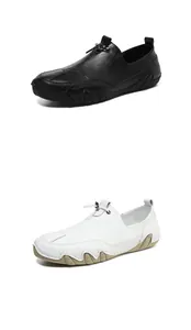 Detail of black and white leather loafers with unique rubber side soles and metal buckle