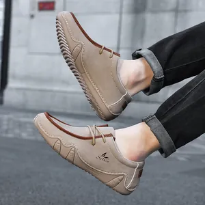 Detail of khaki men's loafers with Salkin logo and non-slip soles in city setting