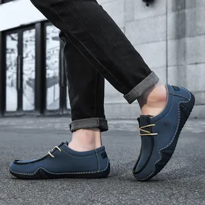 Detail view of navy blue suede casual loafers with contrast stitching and yellow laces