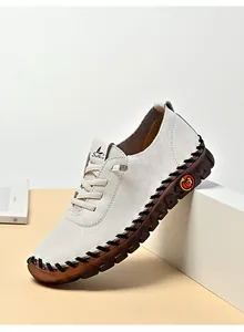 Detail of handcrafted stitching and non-slip rubber sole on beige casual flat shoes