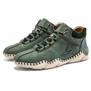 Detail of dark green nubuck leather boots with hand-stitched soles and knited collars
