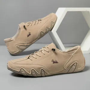 Detail of khaki suede casual shoe with crown goat logo and unique wavy rubber outsole