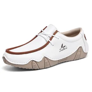 Detail view of white casual men shoes with brown leather trim and side brand logo