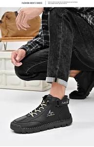 Detail of black leather casual boots with rugged hand-stitching and khaki laces