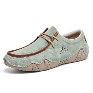 Macro detail of men's sage green leather moccasin showing pebbled texture and non-slip sole