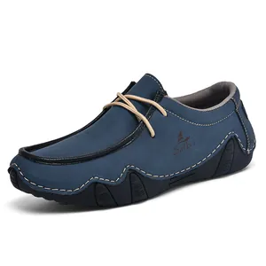 Men's navy blue suede loafers with brown laces and non-slip rubber soles from a side view