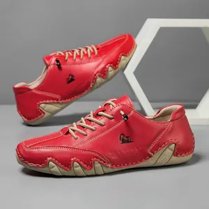 Close-up of red leather casual shoes with wave stitching and sheep logo detail