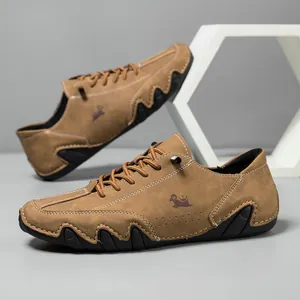 Detail of brown suede men shoes featuring a wavy anti-slip rubber sole and logo