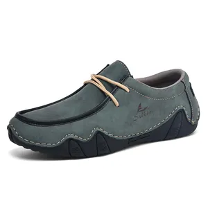 Detail view of men's navy blue suede loafers with contrast stitching and rubber sole