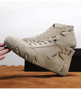 Detail of high-top beige leather sneakers featuring a rugged sawtooth anti-slip sole design