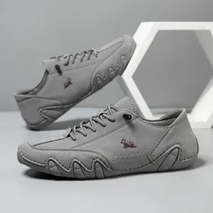 Detail view of grey suede casual shoes with lace-up design and non-slip rubber sole