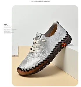 Detail of silver loafers with floral texture, translucent gum sole and heart logo
