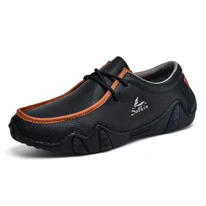 Close-up of black litchi grain leather men shoes with orange trim and Salkin branding