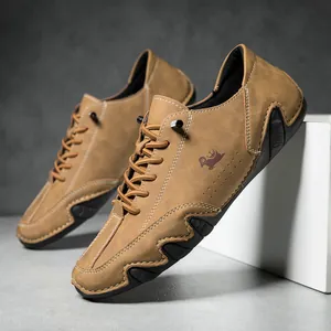 Detail of light brown suede leather men shoes showing side logo and durable rubber sole