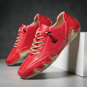 Detail of red pebbled leather casual shoe with thick beige stitching and wavy sole