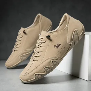 Detail of khaki suede men's casual shoes featuring crown logo and wave rubber sole