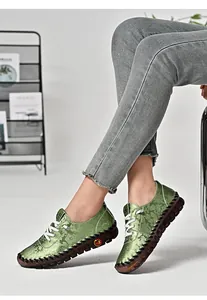 Detail of green floral loafers with thick gum sole and hand-stitched craft details
