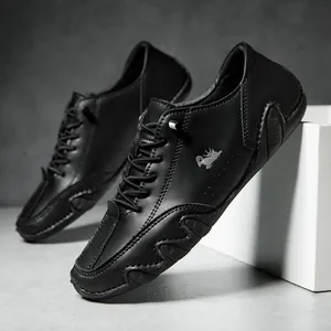Detail of black leather casual shoes featuring a crown logo and anti-slip rubber sole